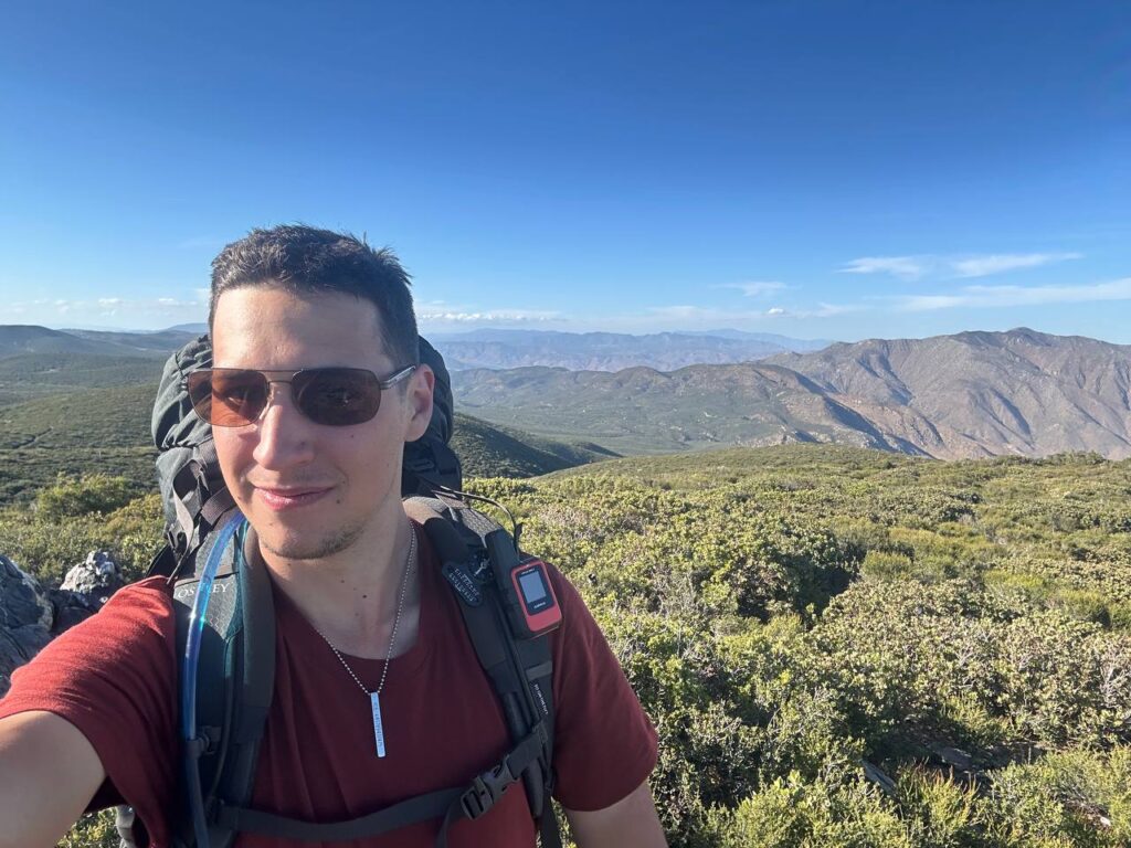 Noah Tobler PCT day 4 selfie mountain panorama Osprey backpack